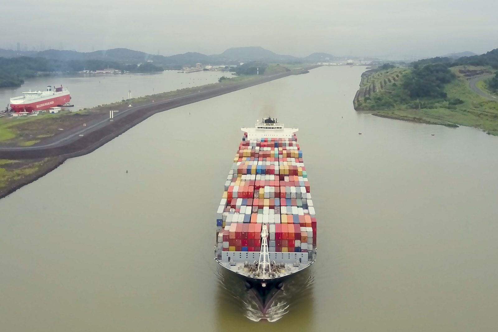 Aerial view of a cargo ship crossing the Panama Canal